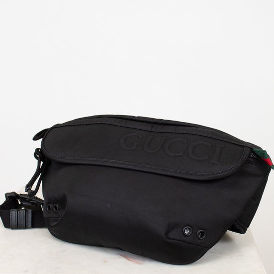 Black Gucci bag on a white background