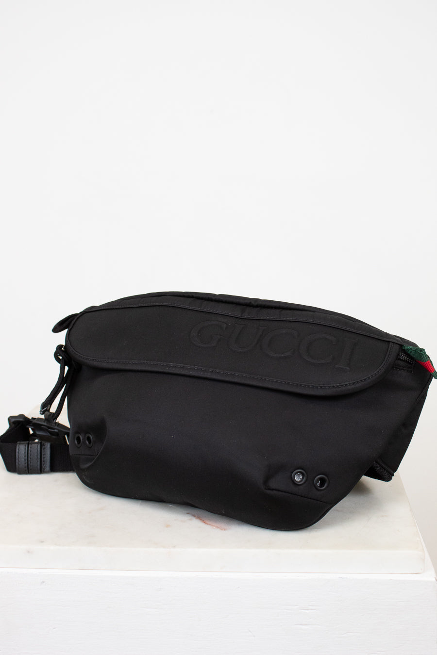 Black Gucci bag on a white background