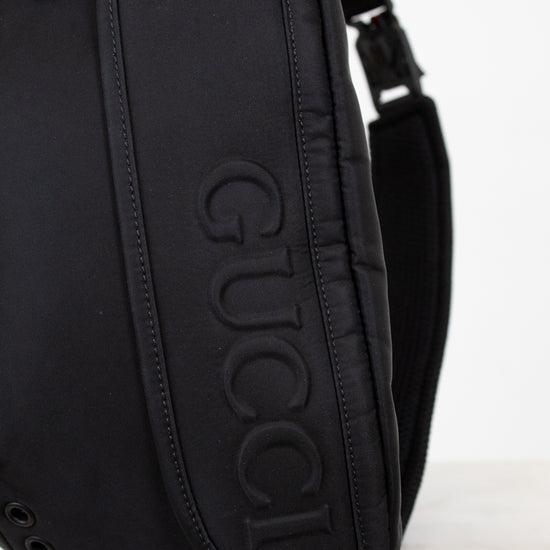 Black Gucci bag on a light gray background