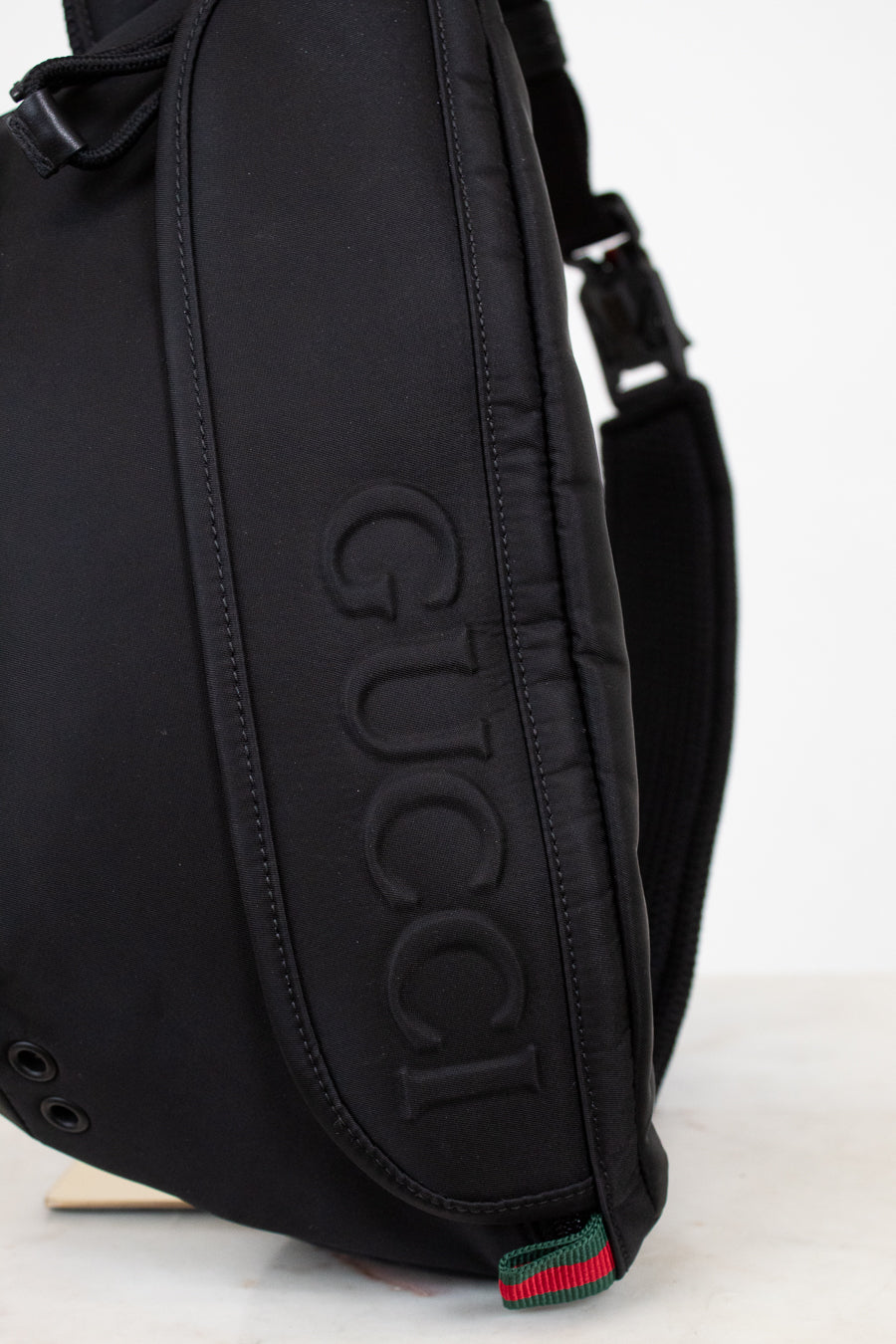Black Gucci bag on a light gray background