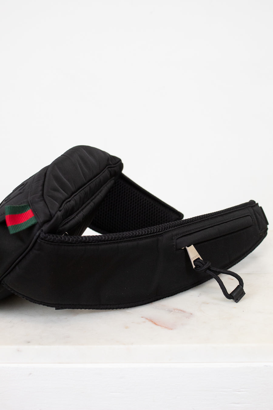 Black strap on sling bag on white background
