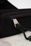 Black bag with Gucci logo on a marble surface