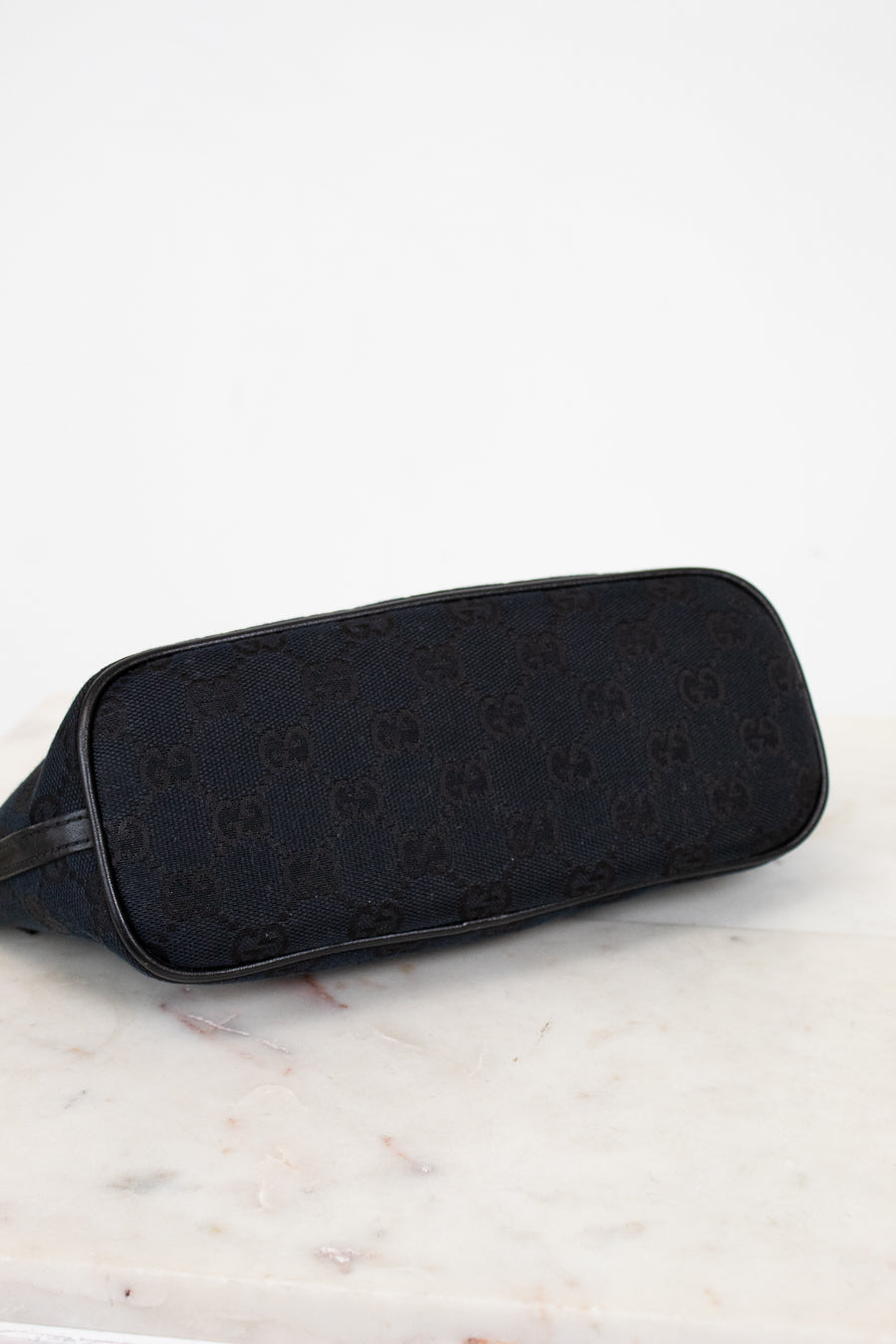 Bottom of black bag on a marble surface
