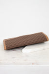 Brown Gucci monogram rectangular clutch purse on a white marble surface