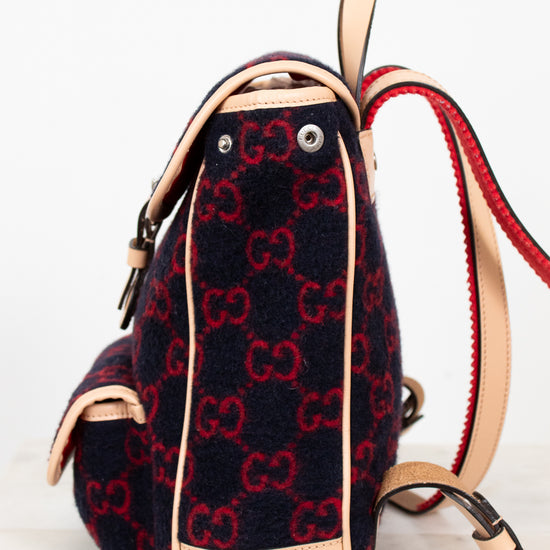 Backpack with red and black pattern on a light background