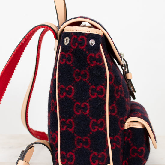 Backpack with red and black pattern on a light background