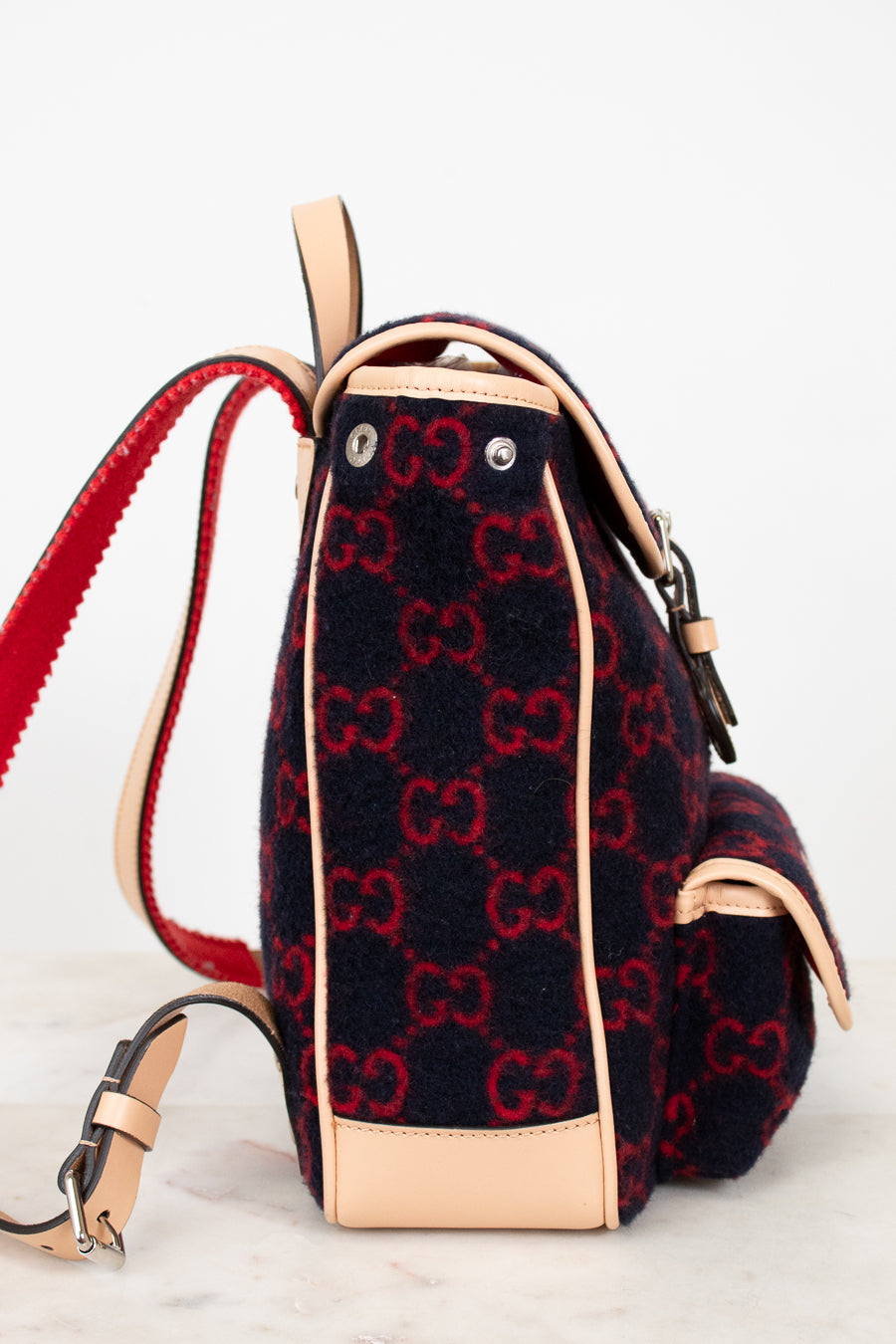 Backpack with red and black pattern on a light background