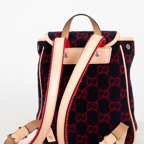 Designer handbag with red and black pattern on a white background