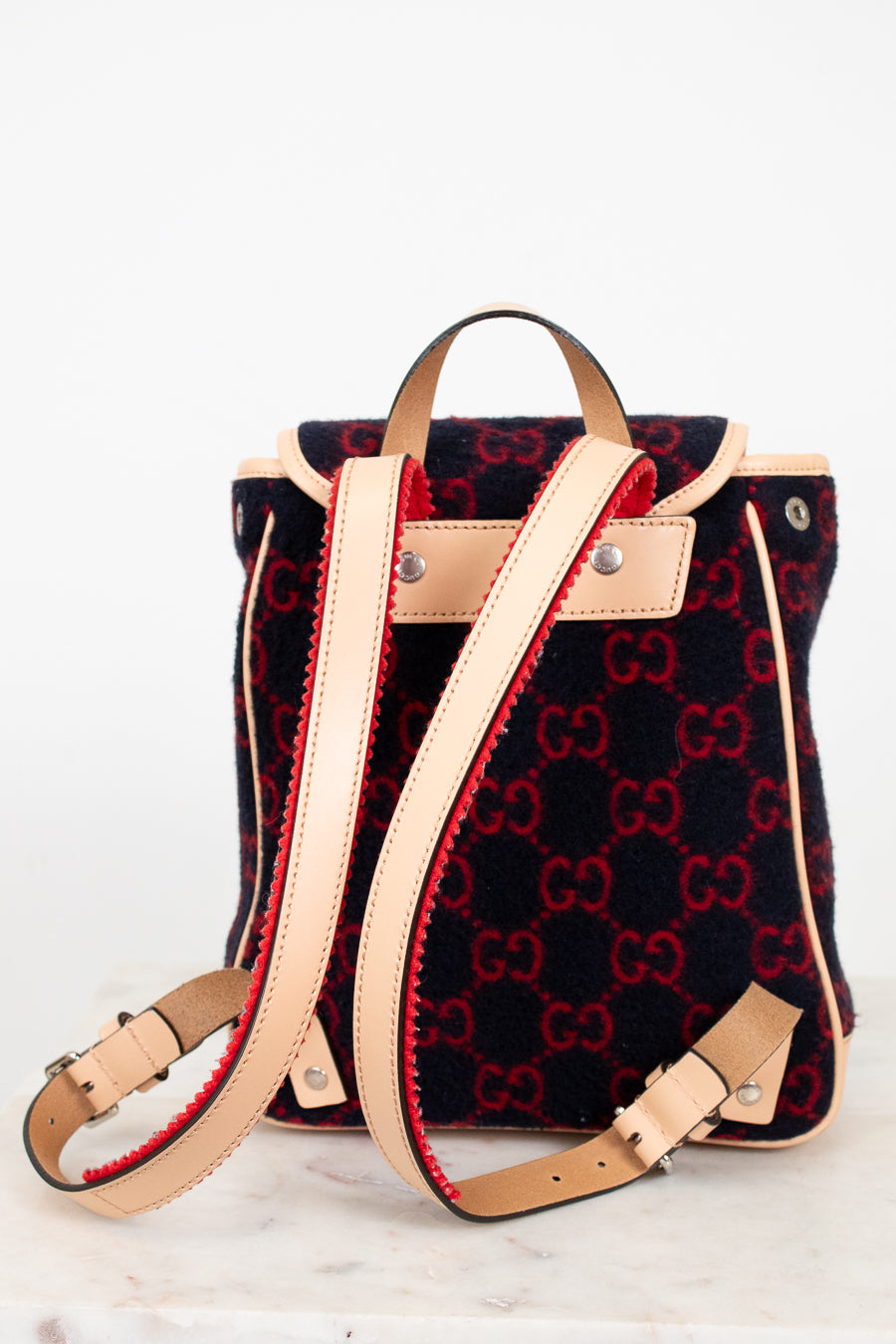 Designer handbag with red and black pattern on a white background