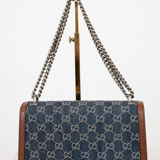 Designer handbag with chain strap on a white background