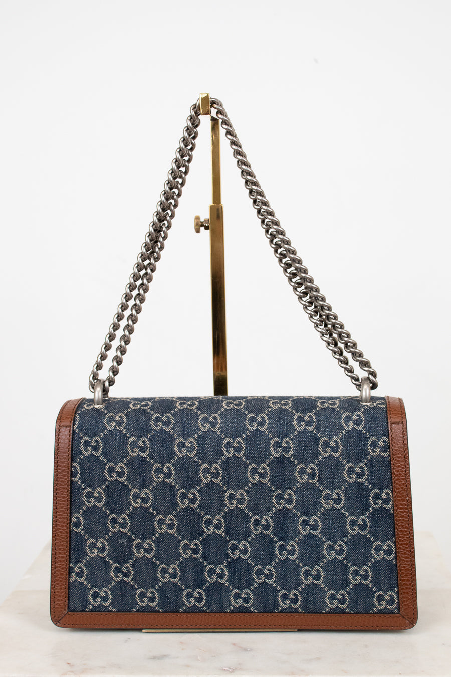 Designer handbag with chain strap on a white background