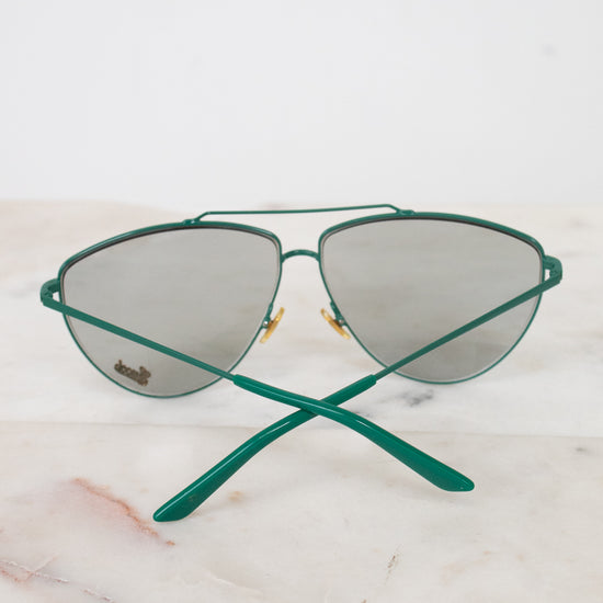 Teal aviator style sunglasses with teal arms visible