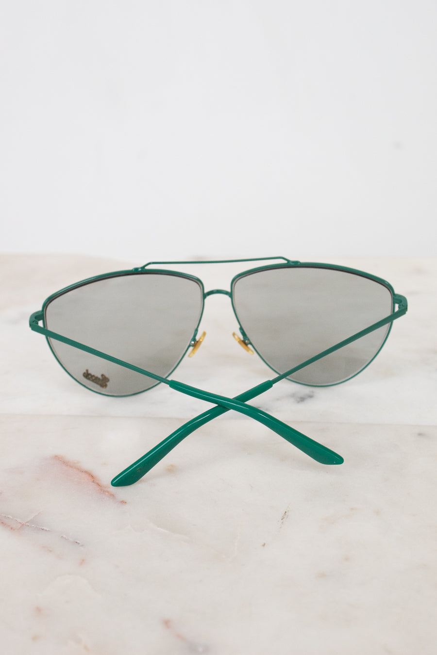 Teal aviator style sunglasses with teal arms visible