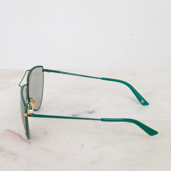 Side view of teal frames with gold-tone accents