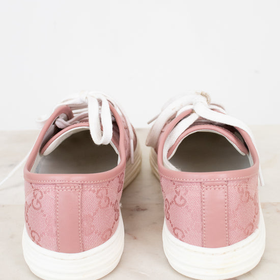 Pair of pink sneakers on a light marble surface