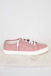 Pink sneaker with white laces on a light gray background
