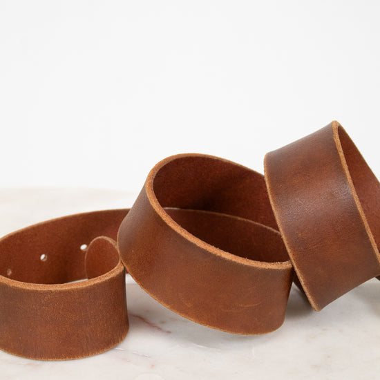 Brown leather belt on a marble surface