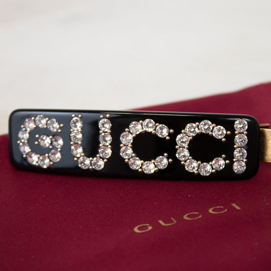 Gucci hair clip with rhinestones on a red background