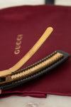 Hair clip on a Gucci branded red pouch