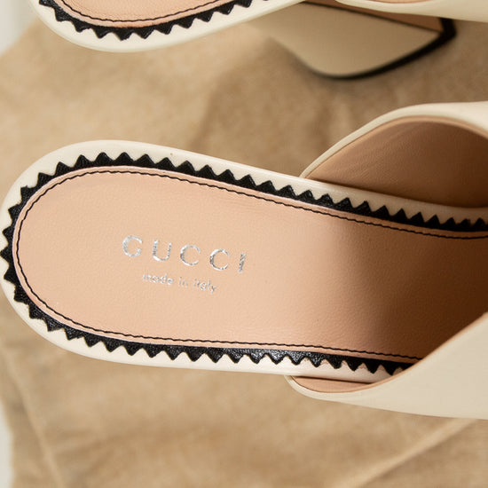 Close-up of Gucci sandals with a beige background