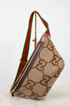 Beige belt bag with large brown gucci monogram logo with a green and red striped strap on a white background