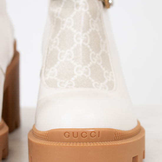 Gucci cream boots with platform tan sole on white background
