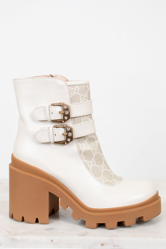 Gucci cream boots with platform tan sole on white background