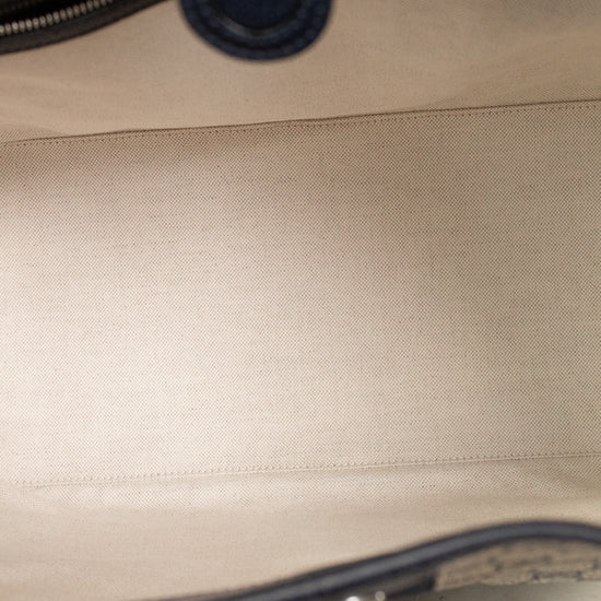 View of light fabric interior with navy leather bordering details