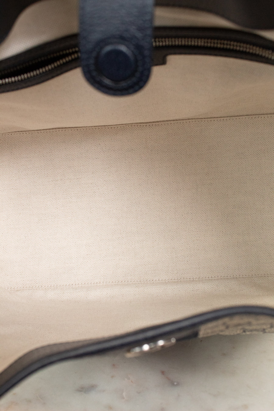 View of light fabric interior with navy leather bordering details