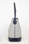 Close-up of side view of tote bag showing a GG monogrammed print against a plain background 