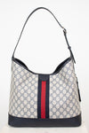Back view of a monogrammed tote bag showing red and navy center stripe against a plain background