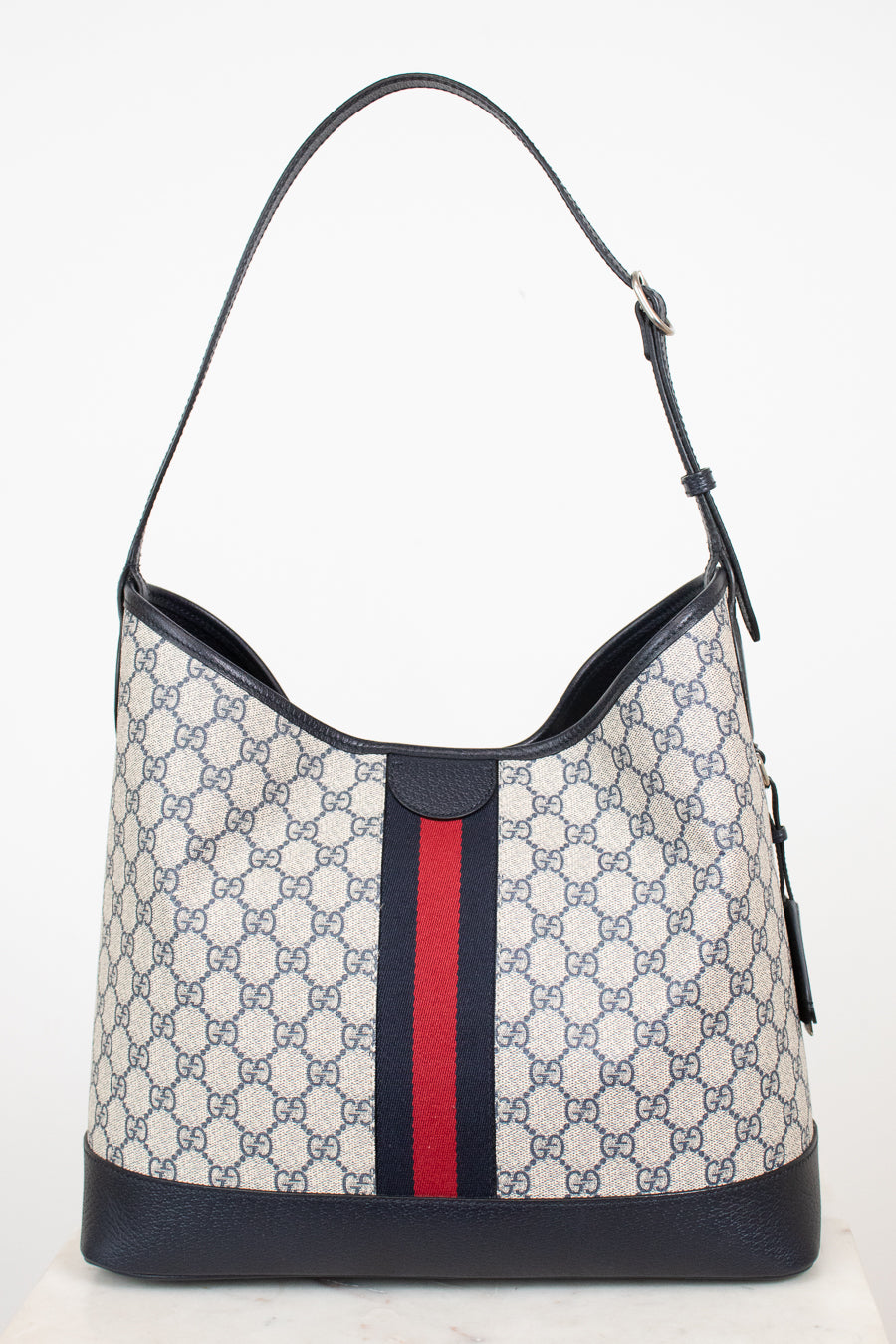 Back view of a monogrammed tote bag showing red and navy center stripe against a plain background