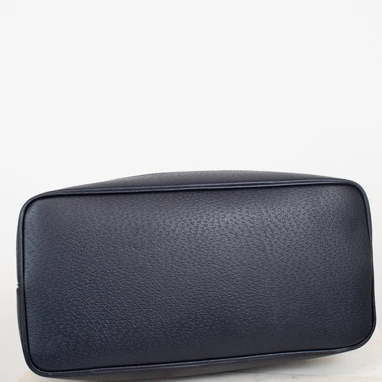 View of bottom exterior navy leather of tote bag