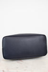 View of bottom exterior navy leather of tote bag