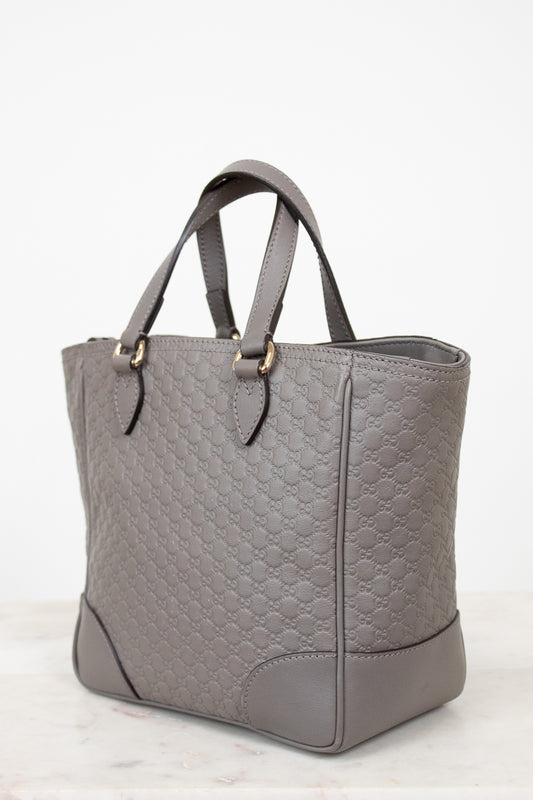Gray quilted handbag on a white background