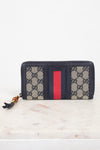 Navy and monogrammed zip around wallet with red and navy striped center detail with gold and bamboo zipper 