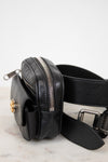 Black leather belt bag on a light marble surface