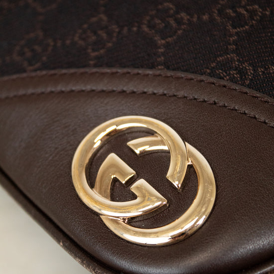 Gucci logo on brown purse with a white surface 