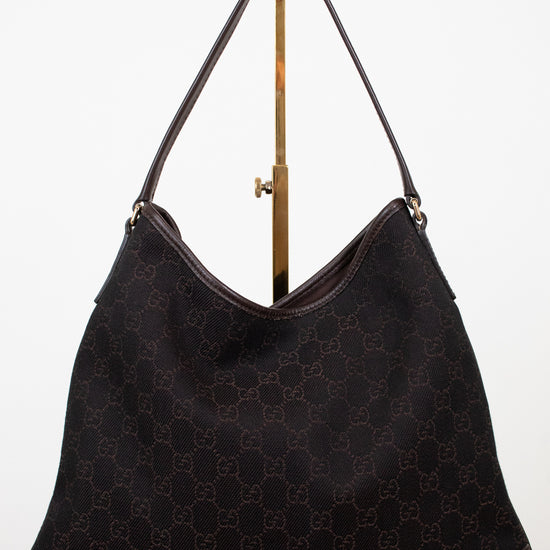 Brown Gucci logo printed purse on white background 