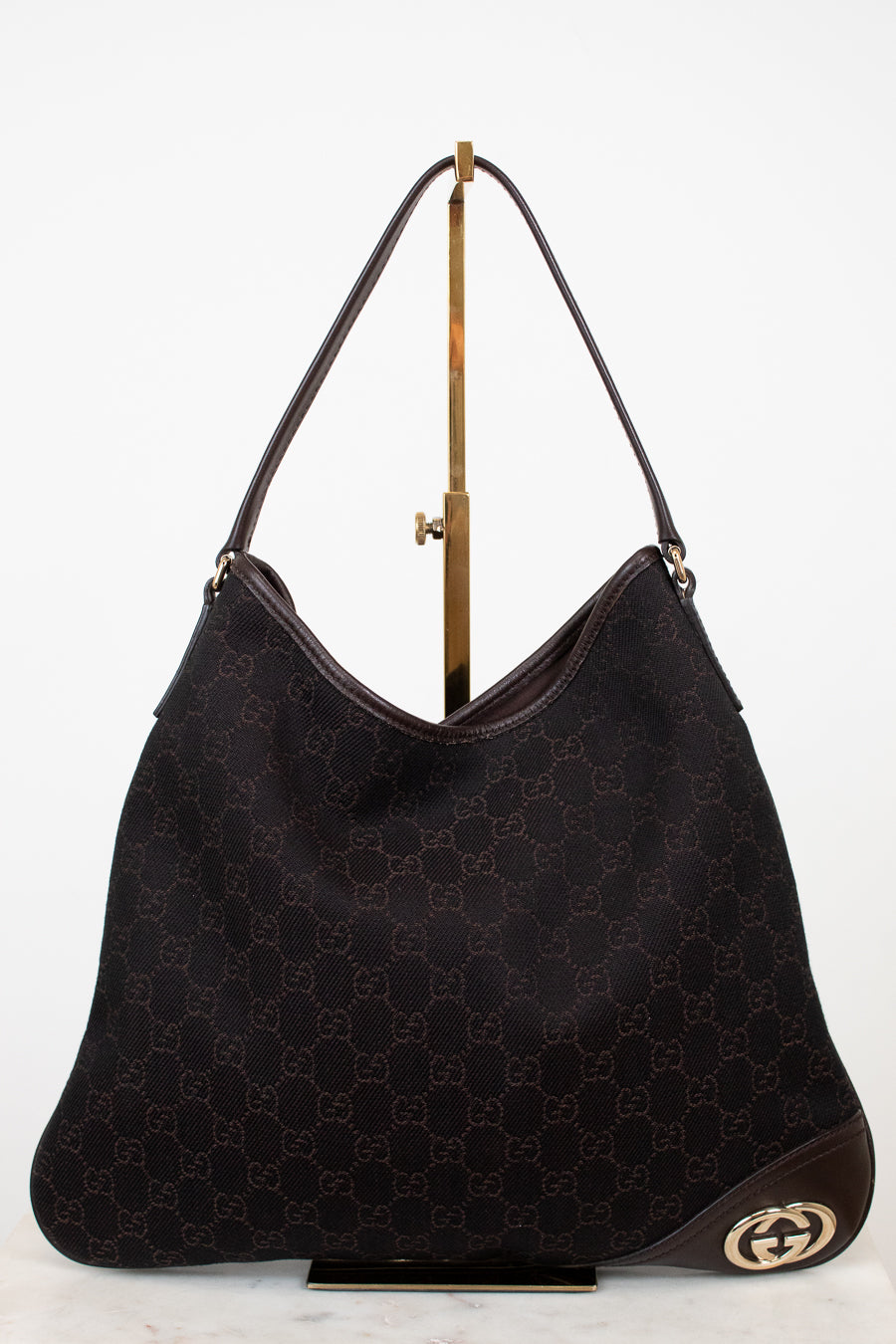 Brown Gucci logo printed purse on white background 