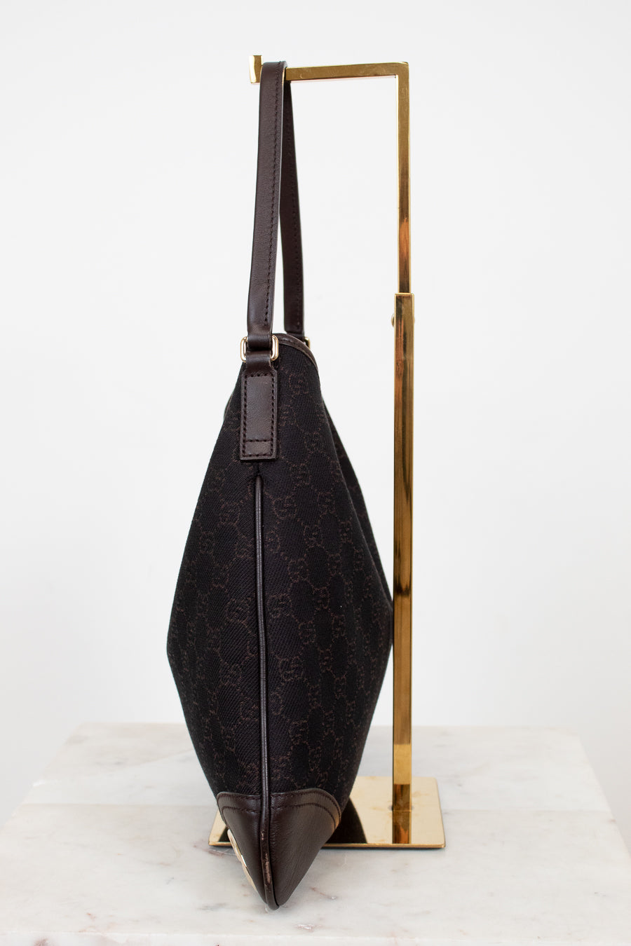 Brown Gucci logo printed purse on white background 