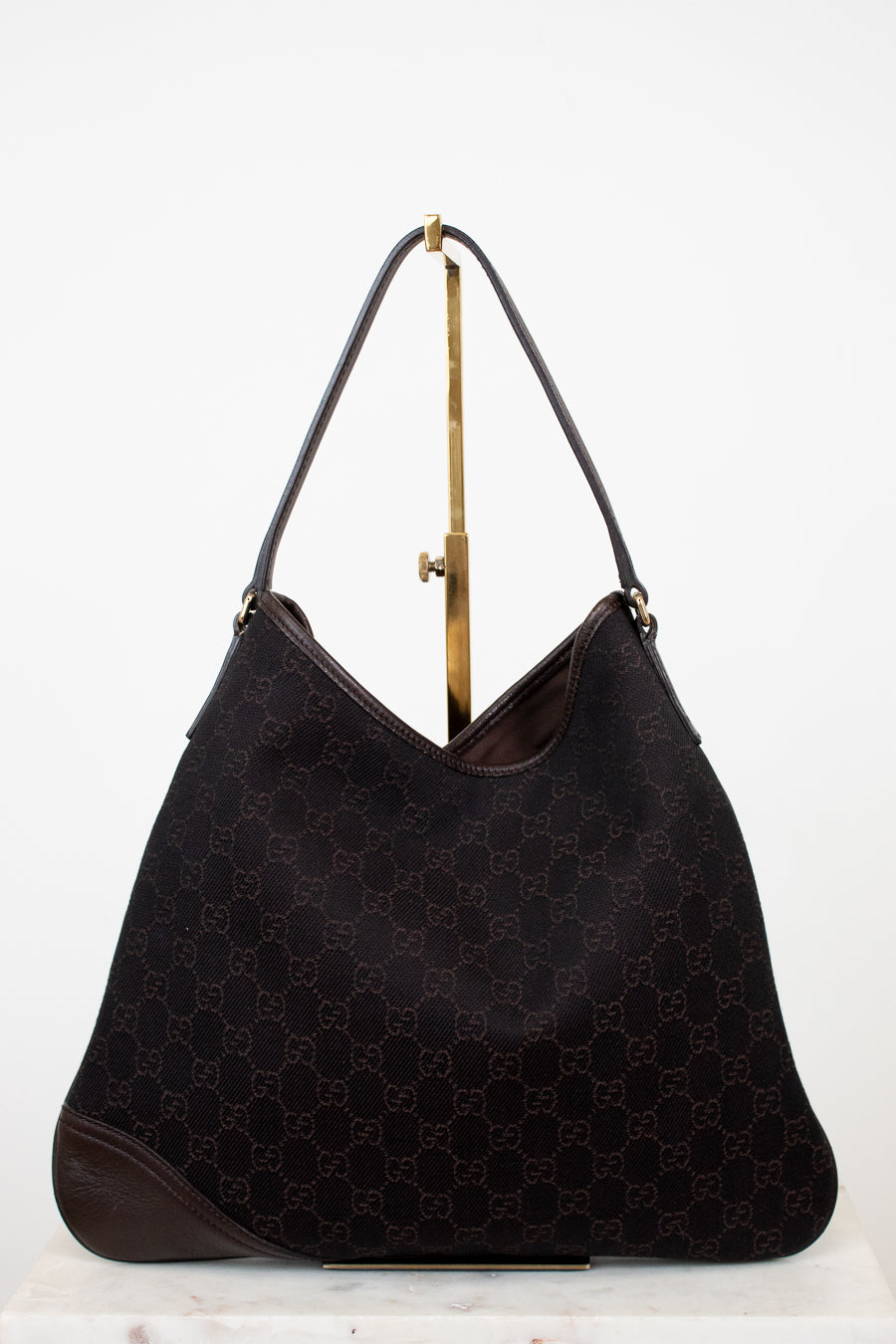 Brown Gucci logo printed purse on white background 