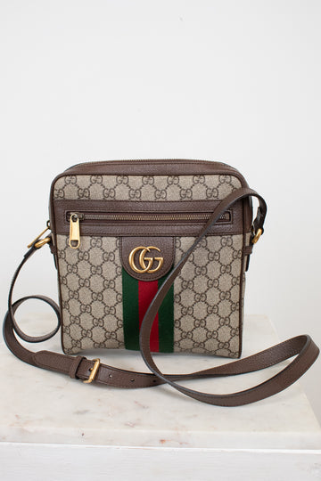Gucci handbag with monogram pattern and iconic logo on a white background