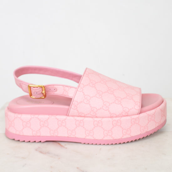 Side view of pink monogram platform sandals