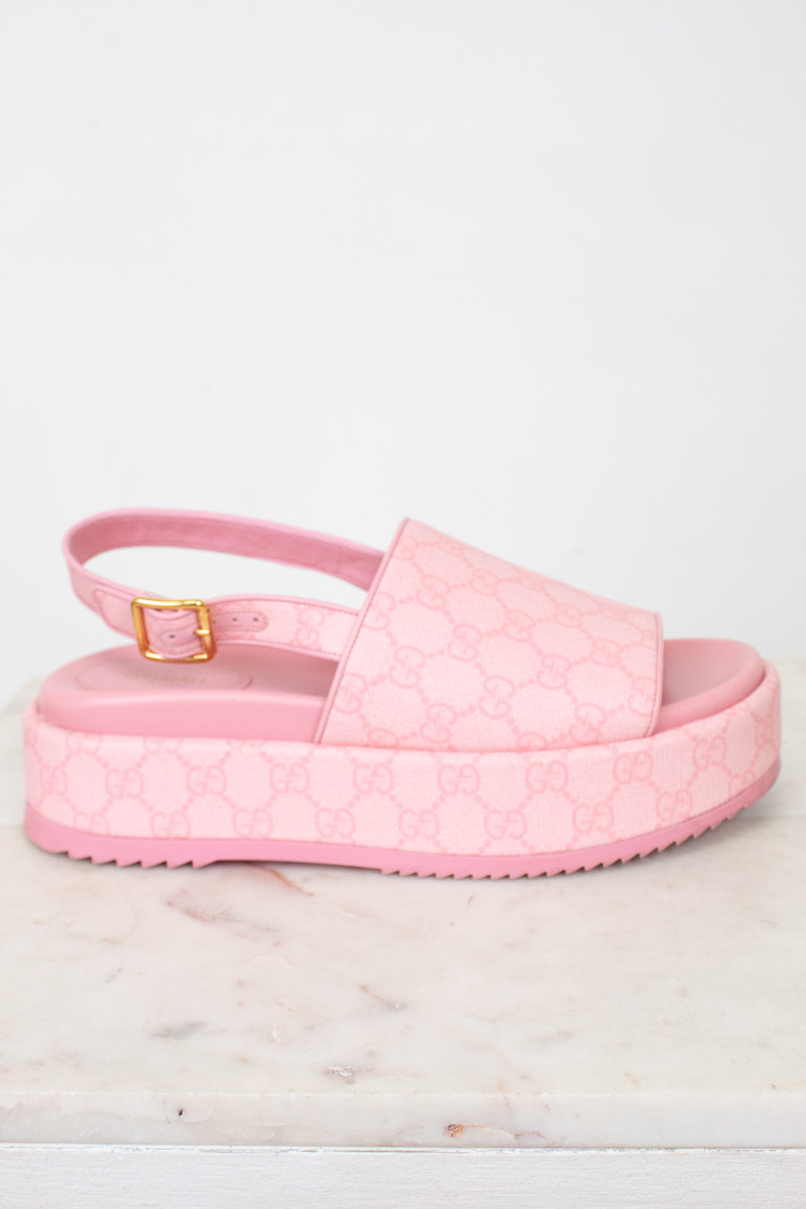Side view of pink monogram platform sandals