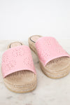 A pair of women's espadrille slide sandals with light pink cutout leather straps and natural jute-wrapped platform soles, displayed on a light marble surface against a white background.
