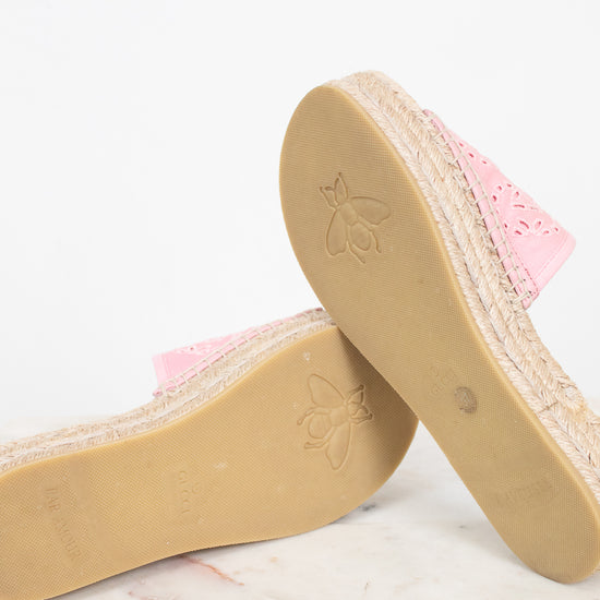 Pink espadrille wedge sandals with jute-wrapped platform soles, shown from the side and bottom on a light marble surface against a white background.