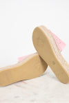 Pink espadrille wedge sandals with jute-wrapped platform soles, shown from the side and bottom on a light marble surface against a white background.