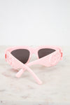 Light pink sunglasses with "GG" logo and dark lenses 