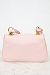 A light pink leather shoulder bag with gold-tone hardware and a matching pink strap, displayed on a light marble surface against a white background.